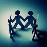 Touch Deprivation’s SHOCKING Biological Fallout Paper cutout figures holding hands, creating a circle with shadows