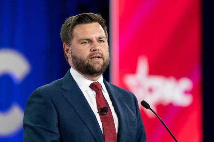 shutterstock_2186937099 (7).jpg A man in a suit speaking at a podium during a conference