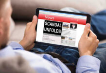 Insider Trading Firestorm Rocks Governor Race Person reading tablet with headline Scandal Unfolds.