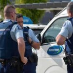 ICE Confrontation — Illegal TikTok Influencer Shot! Three police officers discussing near a police vehicle