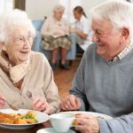 Oldest Person’s Secret Exposed: It’s NOT Her Diet Elderly couple enjoying a meal together in a dining room