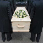 SHOCKING Loss Rocks Music World Forever Four people carrying a coffin with white flowers.