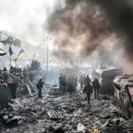 A chaotic protest scene with smoke, fire, and people holding flags