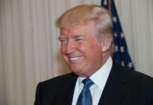 Trump’s Pharma Deal Shocks Washington A smiling man in formal attire with an American flag in the background