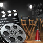Movie set with film reels and clapperboard.