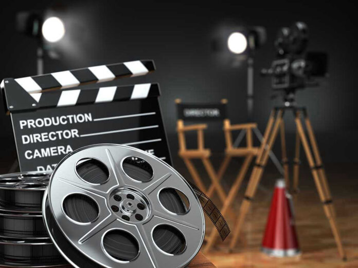 Movie set with film reels and clapperboard.
