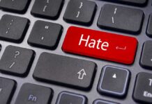 Close-up of a keyboard with a red key labeled Hate