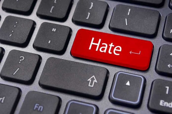 Close-up of a keyboard with a red key labeled Hate