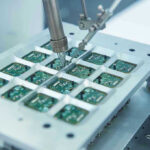 NVIDIA, AMD Hit Hard – CAUGHT In Crossfire Robotic arm assembling electronic circuit boards in production.
