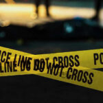 Familicide Horror Shakes “Safe” City Police tape marking a crime scene at night.
