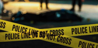 Police tape marking a crime scene at night.