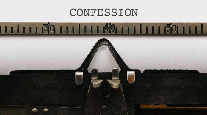 579321010 Typewriter with CONFESSION on paper.