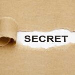 Undercover Teen Sting SNARES PREDATOR A torn piece of brown paper revealing the word SECRET underneath