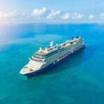 Cruise Line DENIES Rescue—Coast Guard Proves Otherwise A large cruise ship sailing on a calm blue ocean