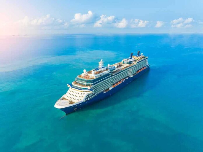 A large cruise ship sailing on a calm blue ocean