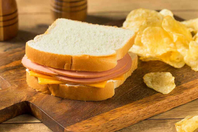 1508127167 Ham and cheese sandwich with potato chips.