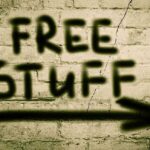 ICE Meals Offer Lands RESTAURANT in Hot Water Graffiti on a brick wall stating FREE STUFF with an arrow