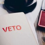Governor’s Veto CRUSHED — GOP VICTORIOUS A close-up of a page with the word VETO stamped in red ink