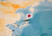 Japan ABANDONS Peace Pledge—Aims Weapons at China Map of Japan with flag pin placed nearby