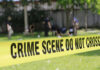 Bloodied Teen with Knife: A Suburban Nightmare Yellow crime scene tape blocking grassy area.