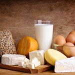The “Cheese Reaction” Doctors Fear Assorted dairy products including cheese, milk, and eggs on a wooden surface