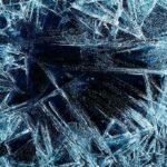 Abstract ice patterns on a dark surface