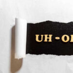 DOJ EXPOSES Unbelievable ERRORS in Voter Rolls Torn paper revealing UH-OH text underneath.