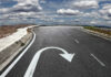 Curved road with a U-turn arrow marking.