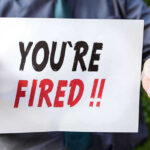 Secret Pentagon Rift–Navy Leader Ousted Person holding YOURE FIRED sign.
