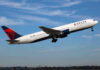 Delta airplane taking off from runway.