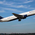 Delta airplane taking off from runway.