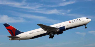 Delta airplane taking off from runway.