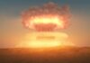 A nuclear explosion creating a large mushroom cloud against a sunset sky