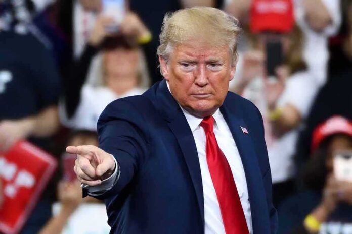 A speaker at a rally pointing towards the audience