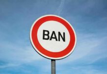 Fear Mounts: YOUNG Men Face Travel Clampdown A road sign displaying the word 'BAN' against a blue sky