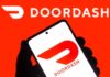 A hand holding a smartphone displaying the Doordash logo against a bright red background
