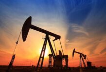 Oil WHIPLASH: Trump Ceasefire Shocks Markets Silhouetted oil pumps against a colorful sunset sky