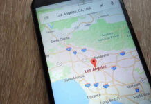 TECH GIANT Caught Altering Burned Lands Smartphone displaying map of Los Angeles, California.