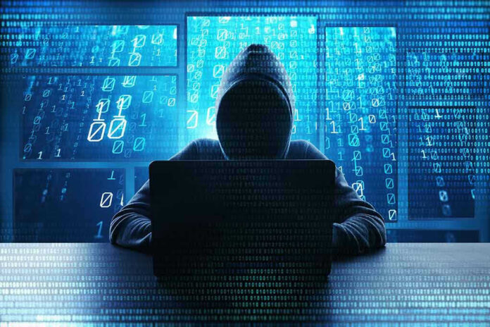 1198362232 Person in hoodie using a laptop with digital code.