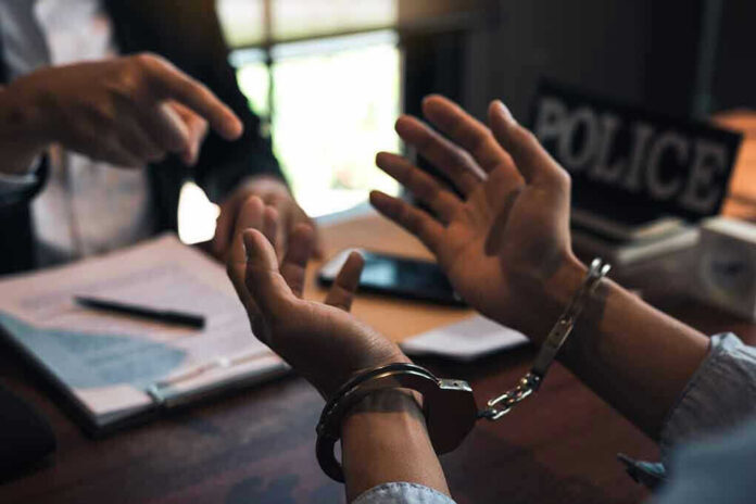 1669066165-8 Person handcuffed in discussion with another person
