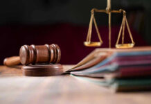 Judges gavel, scales of justice, and legal documents.