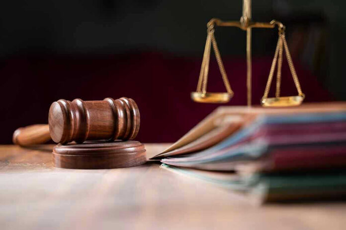 Judges gavel, scales of justice, and legal documents.