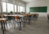 Arizona School REELING After SCANDAL — UNTHINKABLE DISCOVERIES Empty classroom with desks, chairs, windows, and chalkboard.