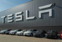 Tesla facility with parked cars in front.