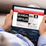 Cake Recipe COVER-UP in DOJ Scandal! Person reading tablet with headline Scandal Unfolds.