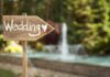 Media SPIN Tries to HIJACK Trump Jr. WEDDING! Wooden sign pointing towards a wedding venue