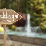 Media SPIN Tries to HIJACK Trump Jr. WEDDING! Wooden sign pointing towards a wedding venue