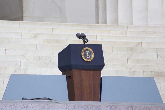 Podium with a microphone and presidential seal in front of steps