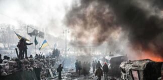 A chaotic protest scene with smoke, fire, and people holding flags