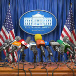 ‘Unconditional Surrender’ Isn’t What It Sounds Like Multiple microphones at White House press briefing podium.